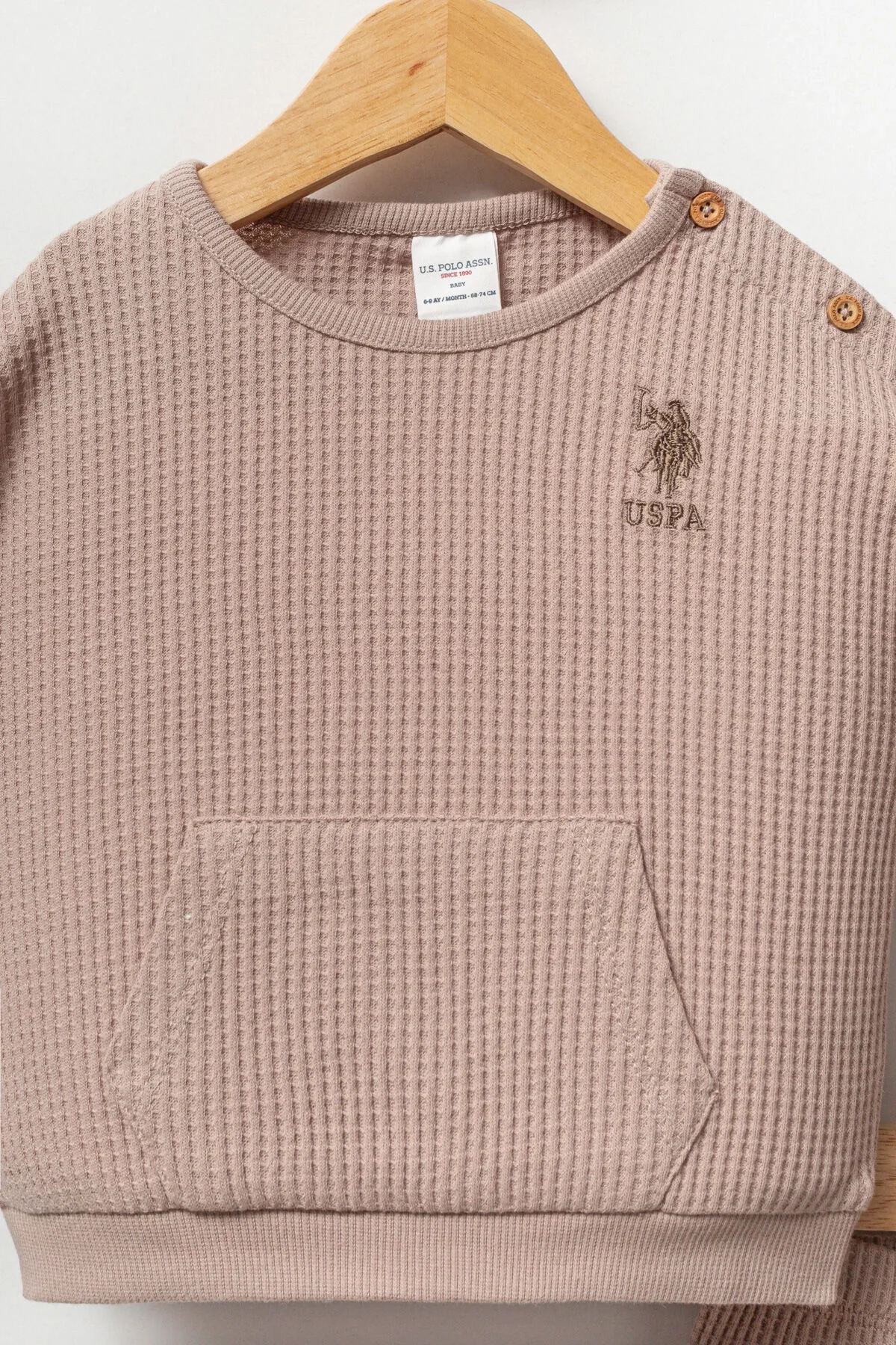Kahverengi waffle dokulu U.S. Polo Assn bebek takım elbise, üst ve pantolon detaylı, ahşap askıda sunulmuş
