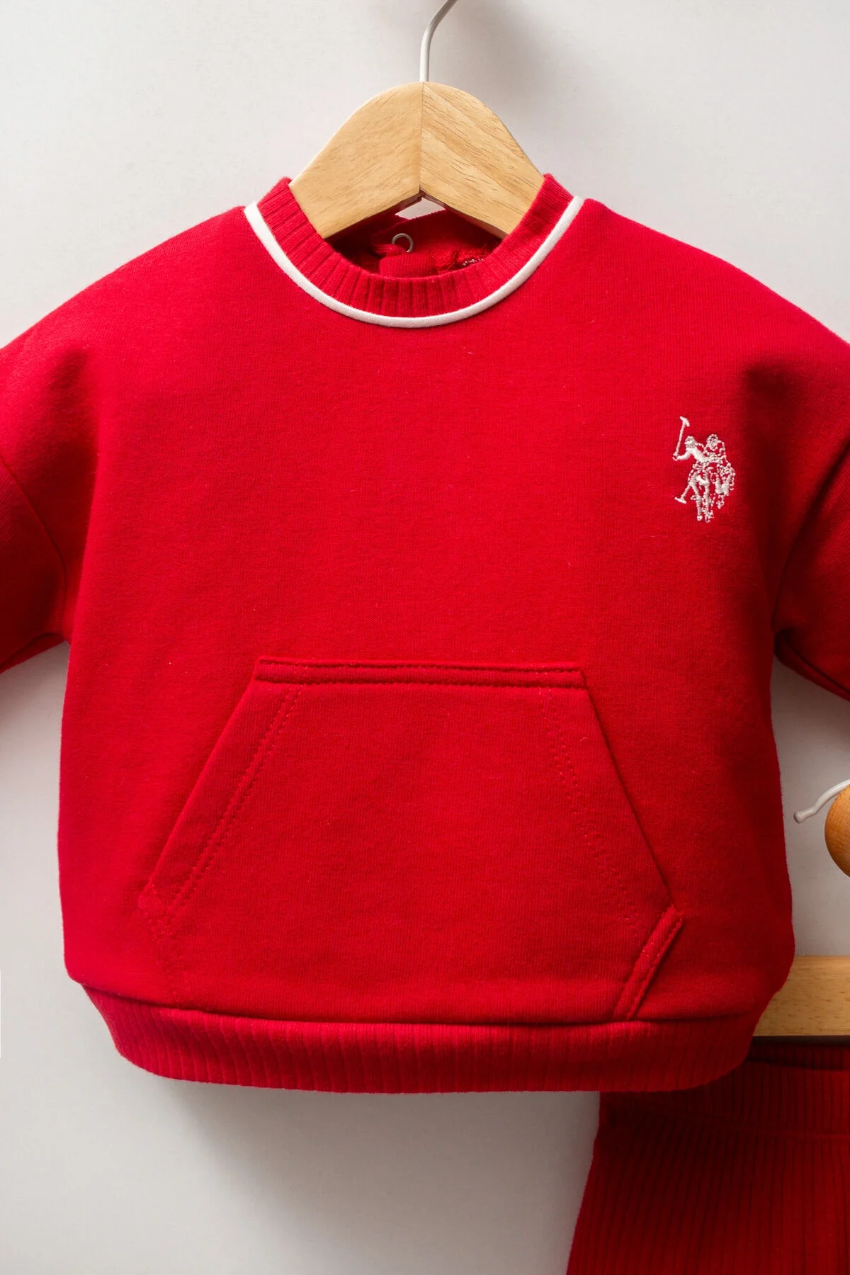 Kız bebeğe uygun kırmızı takım elbette, U.S. Polo Assn marka, uzun kollu üst ve kıvrımlı pantolon, ön cepte, marka logosu