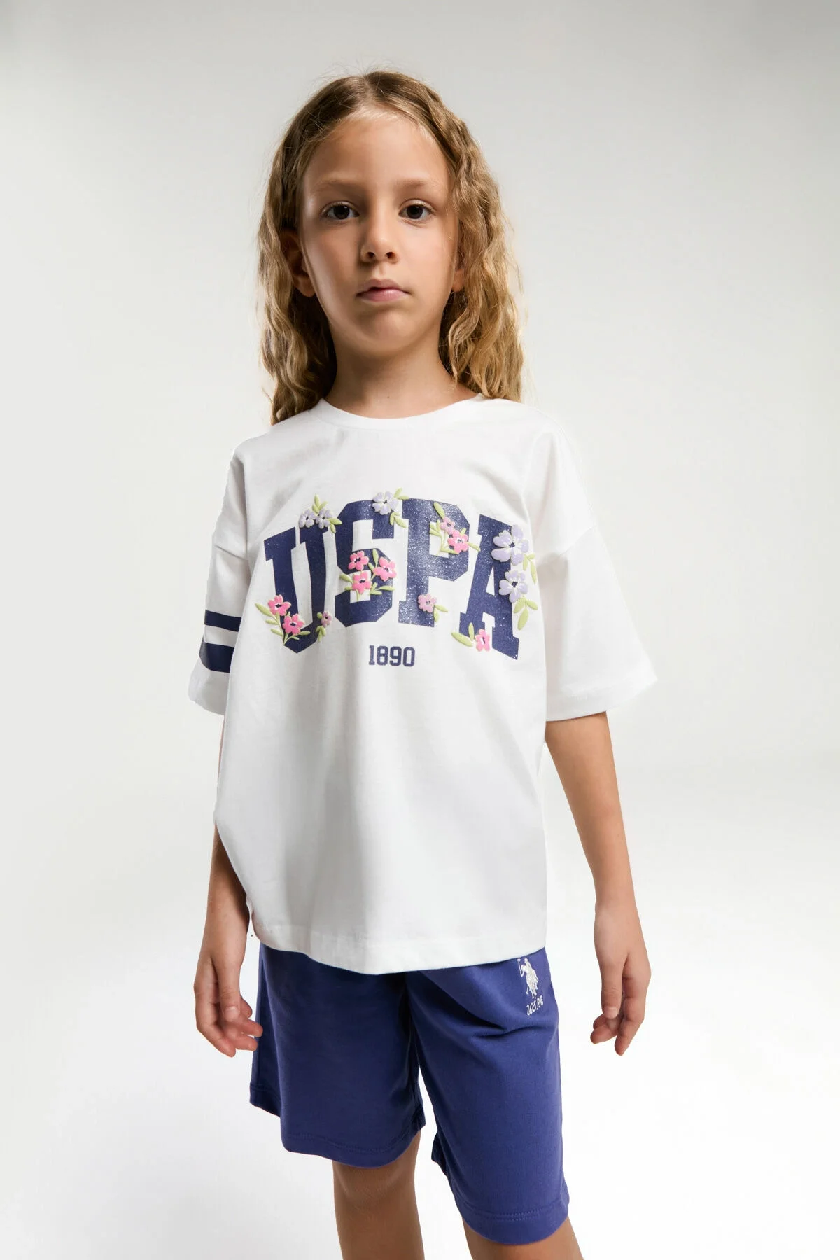 Beyaz U.S. Polo Assn kız çocuk Bermuda takım, mavi kısa pantolon ve beyaz tişört, çocuk giyim modeli