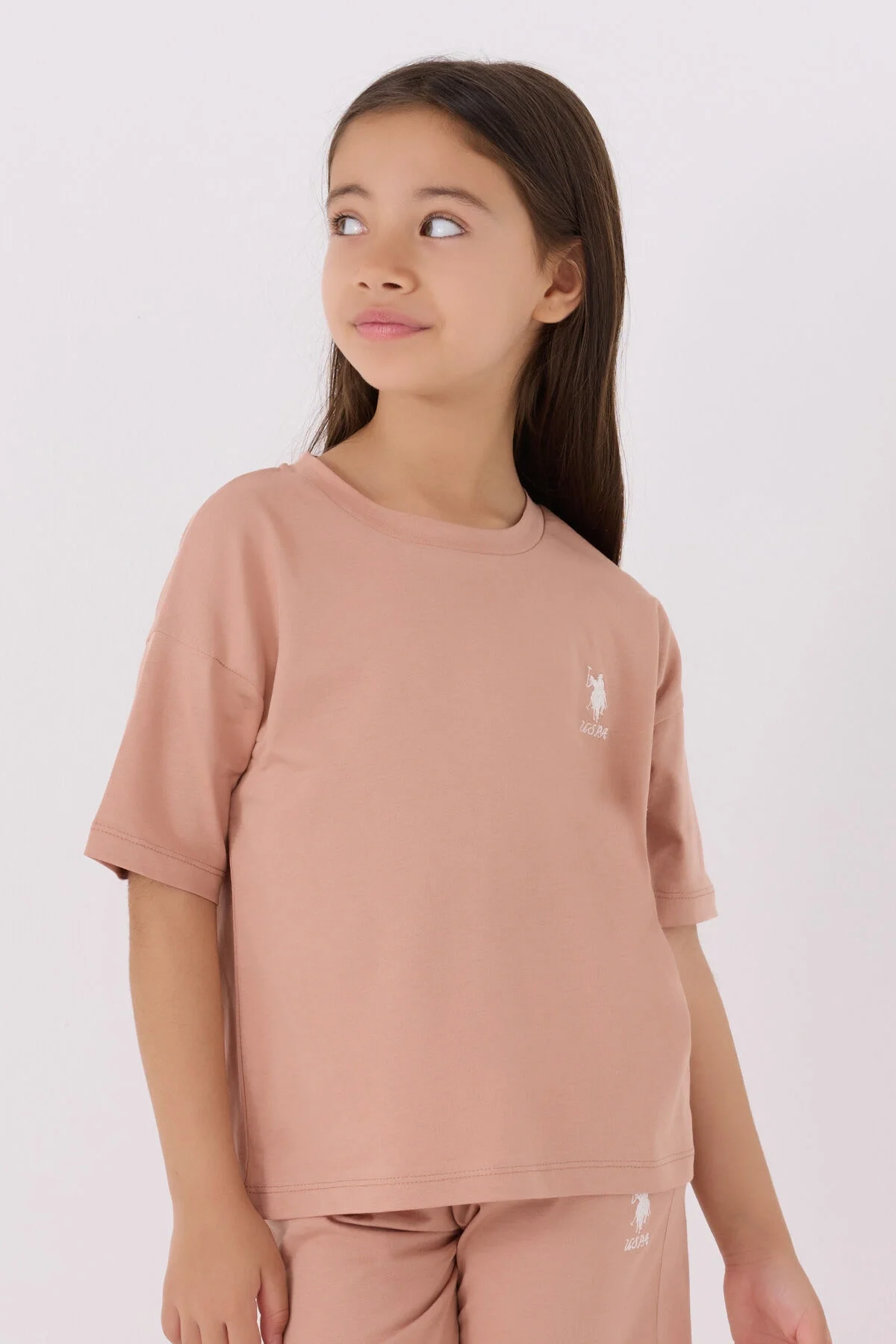 Pembe U.S. Polo Assn kız çocuk Bermuda takım, ön ve yan görünüm, marka logosu, spor ve günlük giyim için ideal